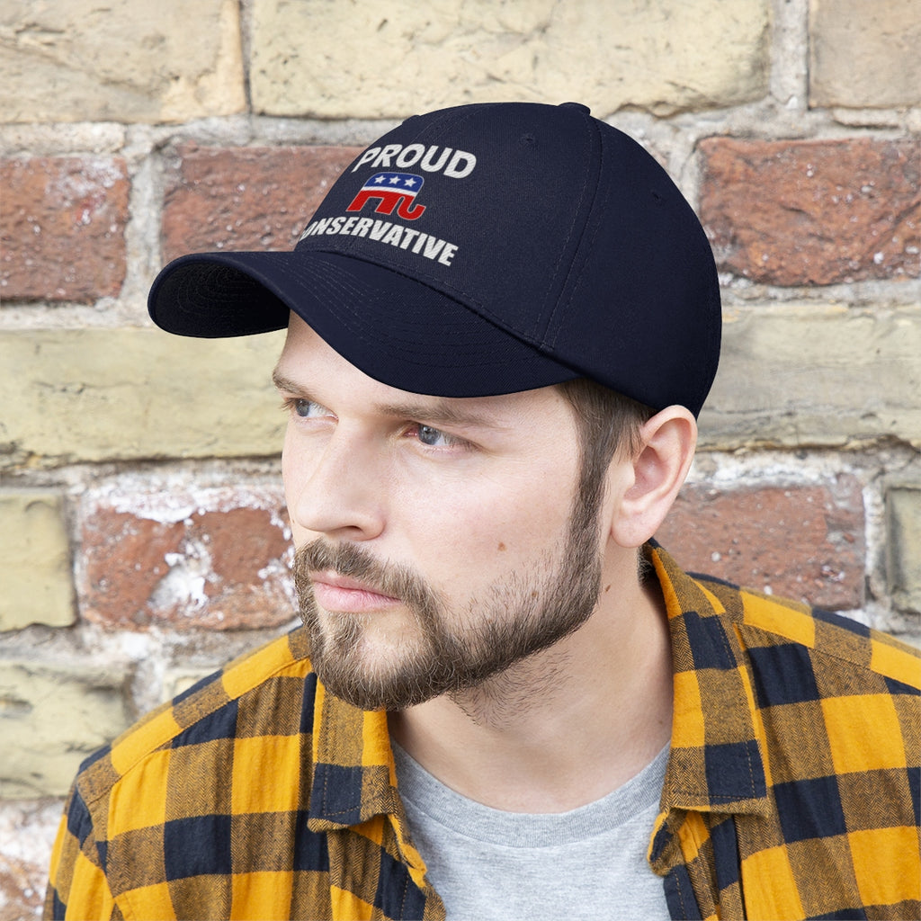 Man wearing Classic Proud Conservative Twill Baseball Cap in front of brick wall, showcasing a bold political statement.