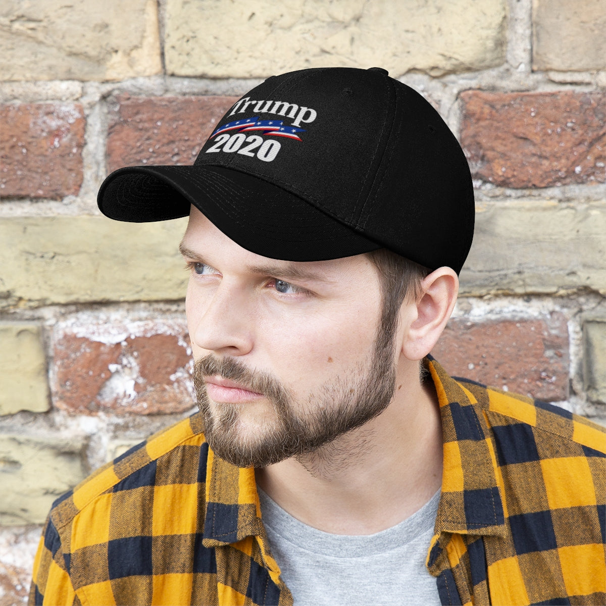 Patriotic 2020 Twill Cap for Trump worn by a man against a brick wall background.