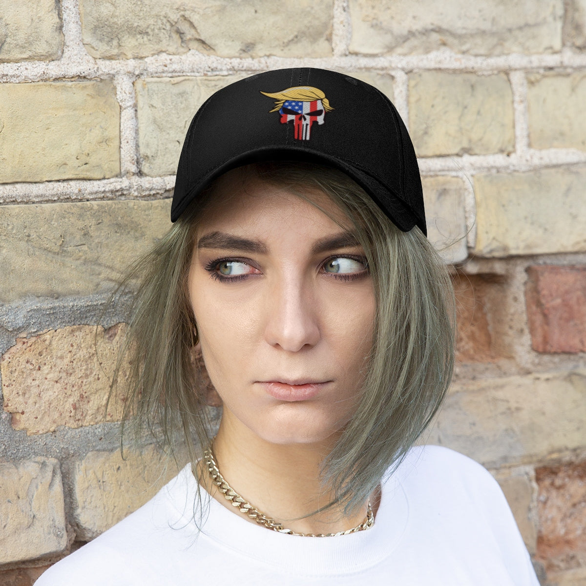 Classic Punisher Twill Cap with Trump Design worn by a person outdoors against a brick wall.