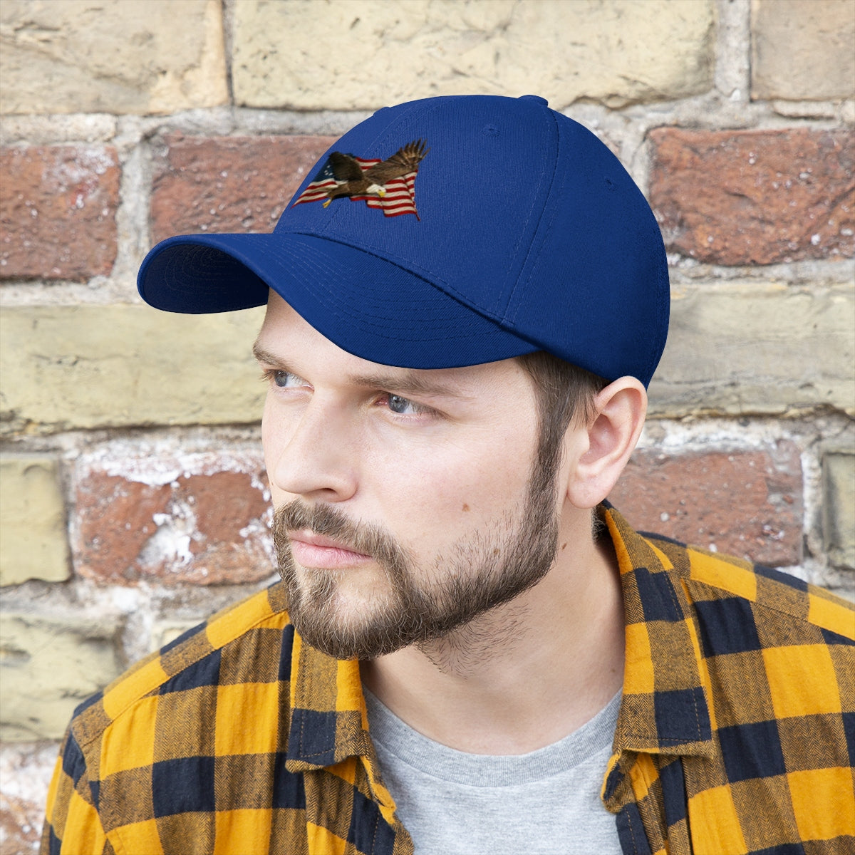 Eagle On American Flag Twill Cap worn by a man, featuring intricate eagle embroidery on a blue cap.