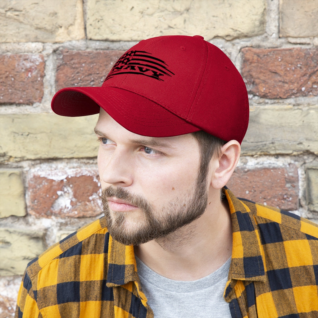Navy On Distressed American Flag Twill Cap worn by a man with a beard, styled with a plaid shirt and a brick background.