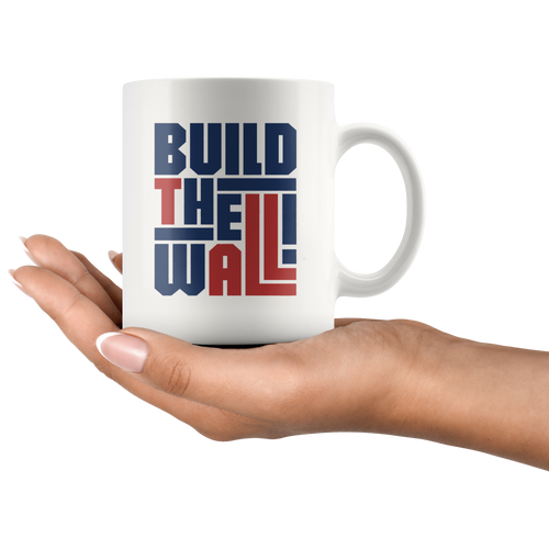 "Build The Wall Patriotic Graphic Design" white coffee mug held in hand