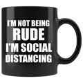 Black mug with humorous text "I'm Not Being Rude I'm Social Distancing" in bold white letters.